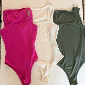 Three SHEIN bodysuits- Pink, White, and Green